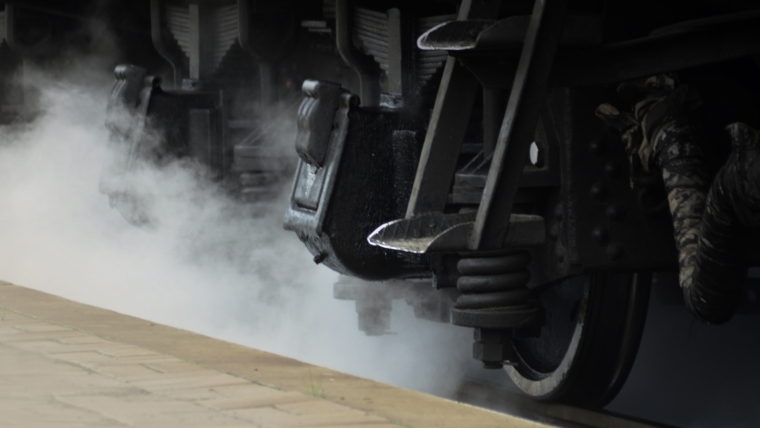 Black wheels of an old USSR locomotive. Vintage wheels of an old soviet freight railcar
