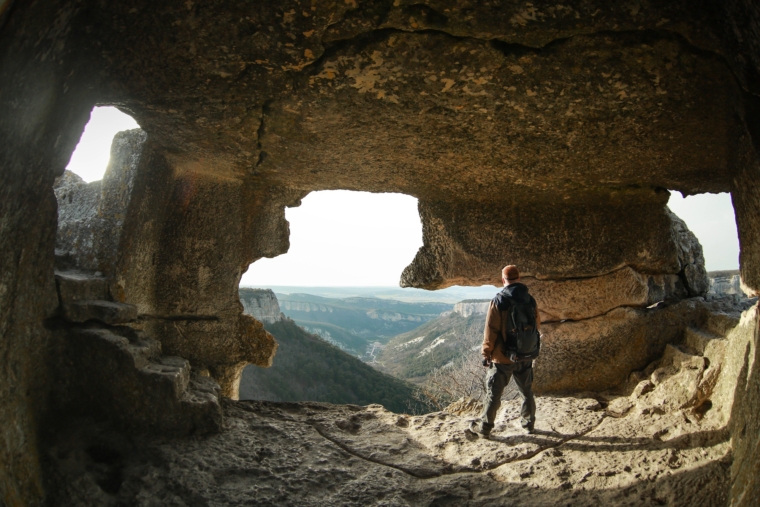 Man stands in high cave