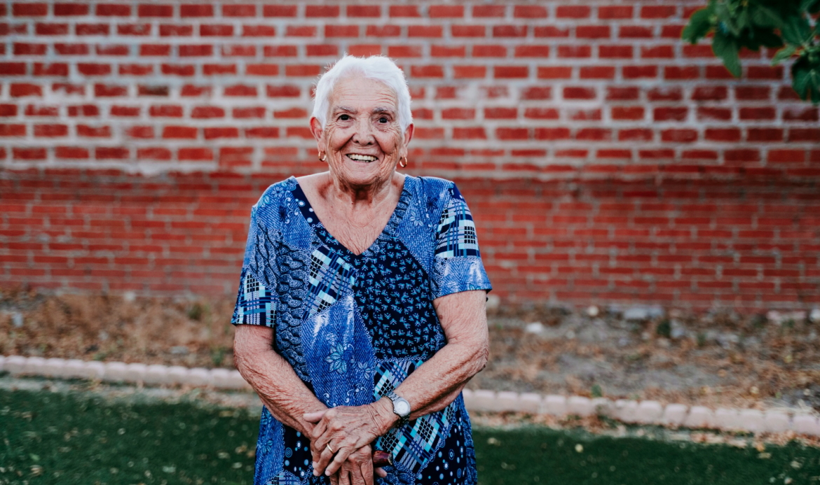 portrait of old lady in her 80s smiling happily