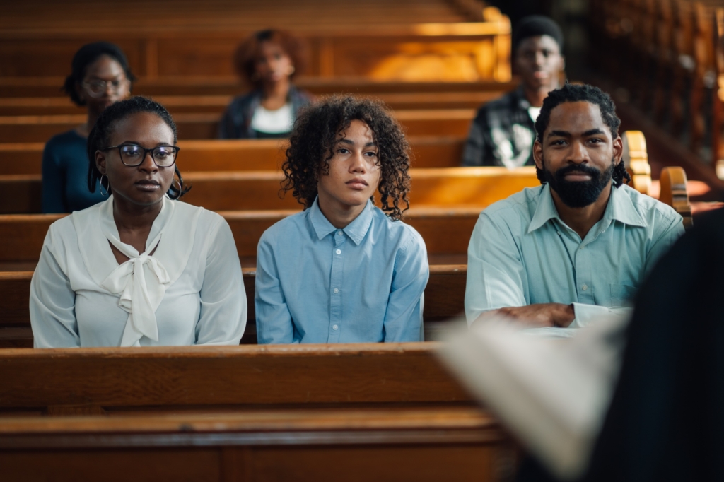 Family sitting in church pew listening to sermon